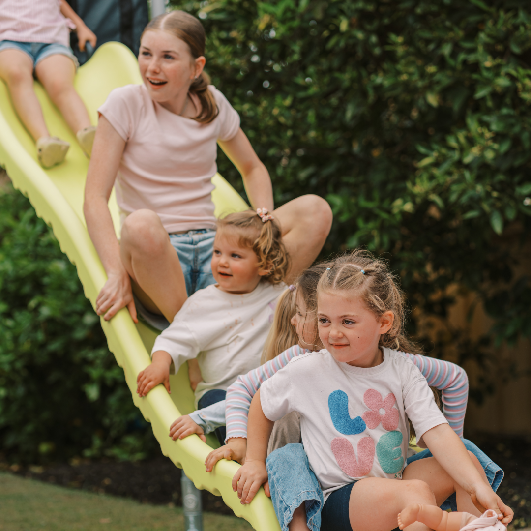 Six kids on a Funky Monkey Bars Tail Slide in Lime